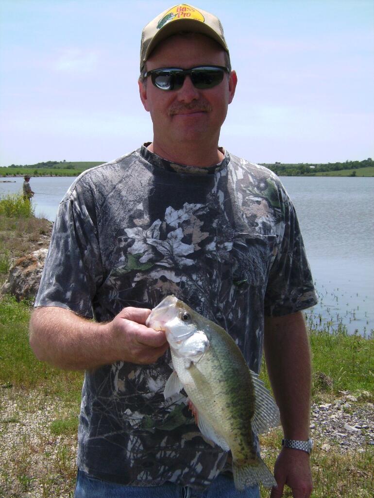 An angler holds his latest catch